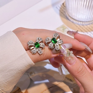 Elegant emerald bow knot earrings in sterling silver with rectangular green crystals