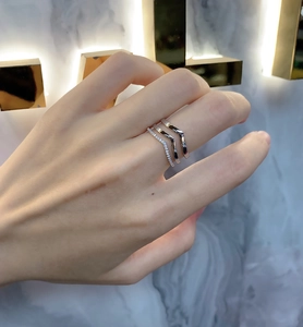 Macro detail of triple-layered V-shaped 925 silver rings with sparkling pavé cubic zirconia