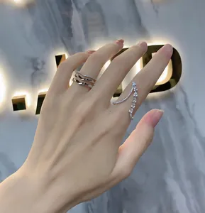 Macro detail of 925 sterling silver chevron ring and curved ring with zircon stones