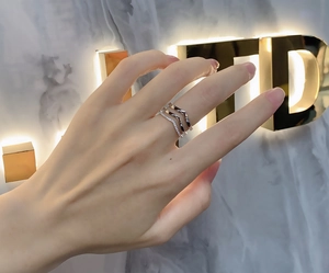 Detail of a 925 sterling silver triple-layer chevron ring with micro-pave crystals