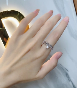 Detail of s925 silver triple-layered chain ring with heart pendant and zircon stones
