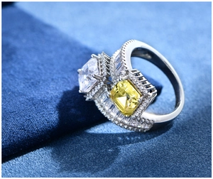 Detail of luxury S925 silver ring with Asscher cut yellow and clear cubic zirconia stones