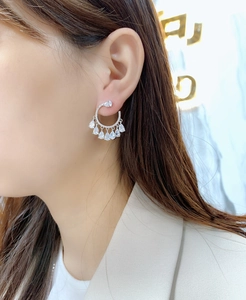 Detail of S925 sterling silver teardrop cubic zirconia tassel earrings on a female model