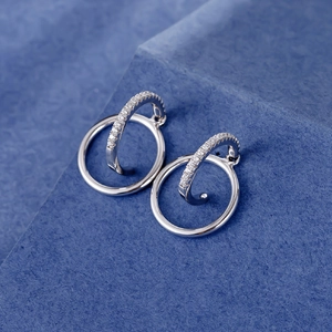 S925 sterling silver double hoop earrings with pavé crystals on a blue background