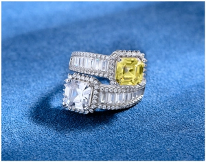 Macro shot of 925 silver ring featuring emerald-cut yellow and white gemstones with pavé stones