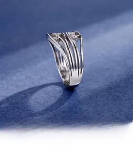 Detail showing multi-layer wave design ring with zircon inlays and platinum texture