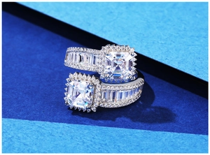 Macro detail of square Asscher cut crystal rings with micro-pave diamonds on silver band