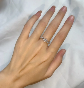 Detailed view of silver vine ring with oval cubic zirconia on model's hand
