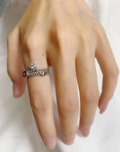 Detailed close-up of a S925 sterling silver triple-layer heart ring with a round zircon