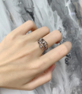Detail of layered S925 sterling silver wavy ring featuring sparkling zircon stones on finger