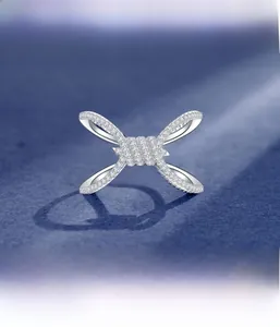 Macro shot of micro-pave setting detail on a silver-tone rope knot ring with cubic zirconia