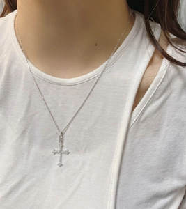 Close-up of S925 silver cross pendant featuring sparkling pave-set cubic zirconia stones