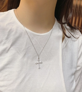 Close-up of sparkling S925 sterling silver cross pendant with pavé cubic zirconia