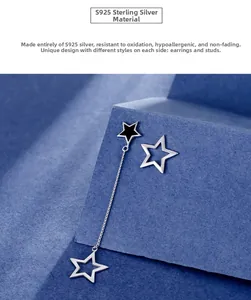 Detail view of asymmetric S925 sterling silver star earrings with long chain tassels