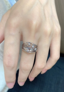 Macro detail of S925 sterling silver layered wave ring featuring five inlaid zircons