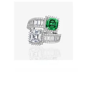 Macro view of Asscher cut emerald and white diamond stones with tapered baguette accents