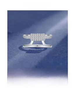 Macro shot of micro-pave setting process details on double-layered silver ring