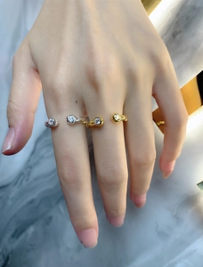 Macro view of minimalist gold and silver open rings with zircon stones on marble