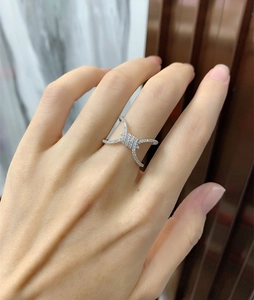 Detailed view of silver barbed wire ring with micro-paved sparkling crystals on a finger