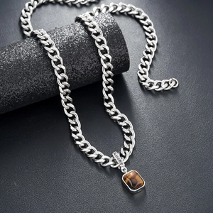 Silver Cuban chain necklace featuring brown tiger eye stone and lucky pendant