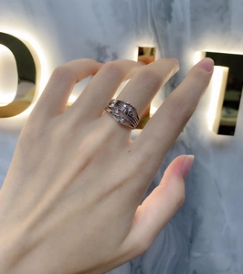 Macro shot of S925 sterling silver wavy ring with small white zircon stone accents