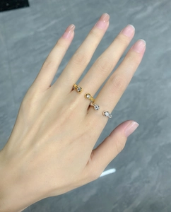 Detail of adjustable twisted silver and gold rings with round cubic zirconia on hand