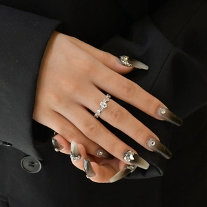 Silver vine band ring with sparkling diamonds worn on hand against black background
