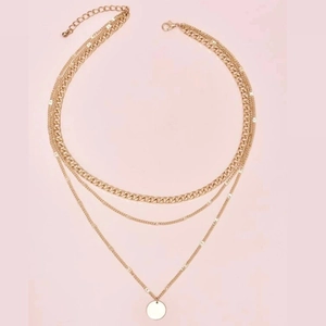 Three-layer gold chain necklace with chunky Cuban links and minimalist round pendant