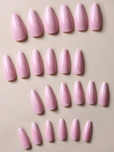 Detailed view of pink almond press-on nails with glossy finish and white waves