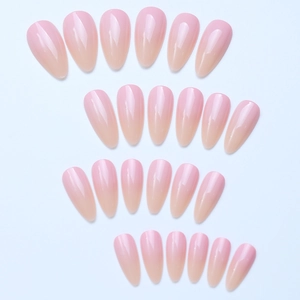 Detailed macro shot of long almond shaped glossy gradient pink press-on nail tips