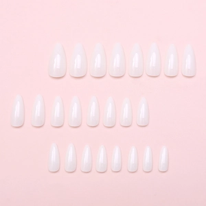Detailed view of glossy white almond-shaped press-on nails arranged on a soft pink background