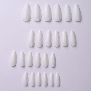 Detailed view of glossy white almond-shaped long press-on nails arranged neatly