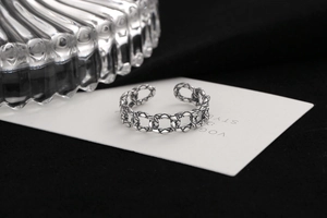 Close-up of vintage S925 silver chain link ring with oxidized finish and adjustable band