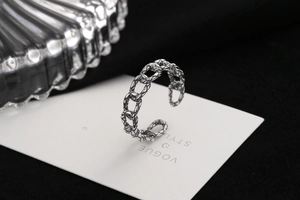 Close-up of vintage silver chain-link open ring with oxidized textured finish details