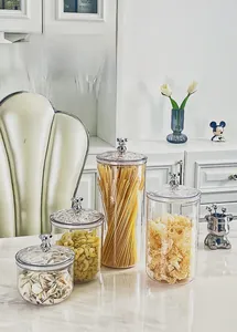 Detailed view of clear plastic food canisters with silver bear handles for kitchen storage