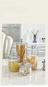 Set of four clear storage jars with silver bear lid handles and ripple texture finish