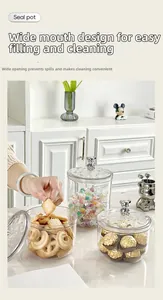Clear sealed jars with silver bear lid handles holding cookies and chocolate snacks