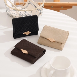 Detailed view of women's short PU leather wallets featuring a golden leaf metal buckle