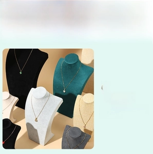 Detail of velvet mannequin bust necklace stands in black green and beige colors