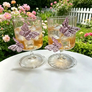 Detail of high borosilicate champagne glasses featuring 3D purple butterfly ornaments