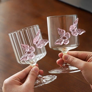 Detail of creative glassware featuring delicate pink glass butterfly ornaments on side