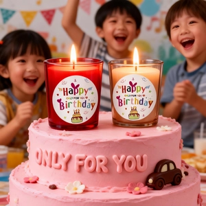 Happy Birthday scented candle set in glass jars on cake with smiling children