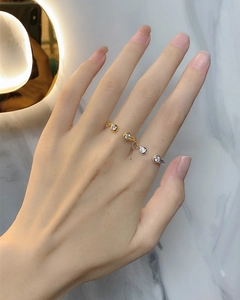Detail of s925 silver twist open rings with round zircon stones in gold and silver