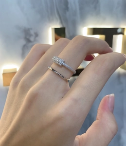 Detailed view of micro-pave cubic zirconia on layered silver rings with polished finish