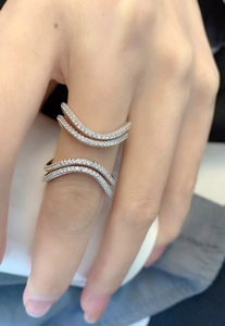 Macro shot of silver layered wavy rings encrusted with white zircon stones for women