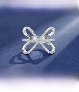 Macro shot of X-shaped silver ring with detailed micro-set cubic zirconia crystals