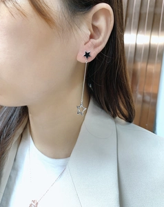 Detail of S925 silver asymmetric tassel star earrings worn for daily fashion look
