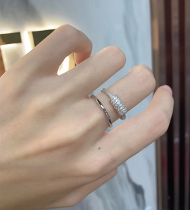 Detail of double-layer sterling silver rings with micro-pave crystals on female hand
