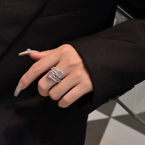 Close-up of 925 silver ring featuring step-cut clear gemstone and pink square diamond