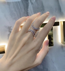 Detail of sterling silver wavy layered ring with pavé micro-zirconia stones on model